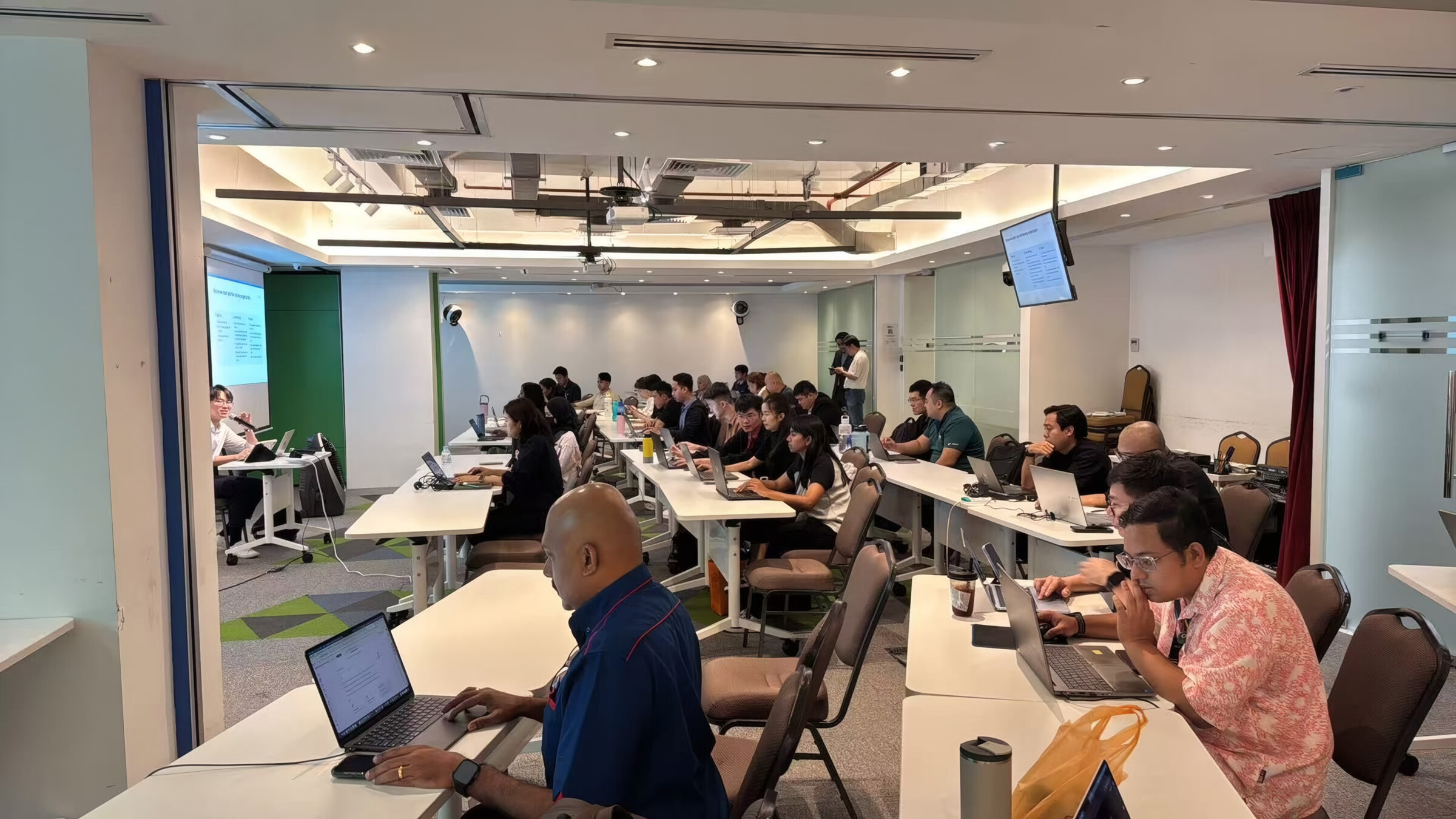 Participants building their apps on laptops